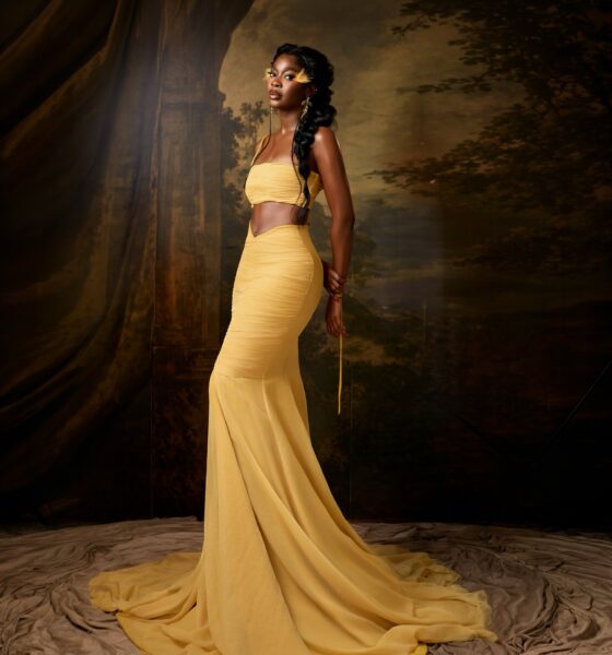 Ashiogwu Precious Dede in a low-rise butter yellow maxi skirt with a sweeping train and bandeau top.