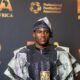 Taiwo Awoniyi holding the PFA Beyond the Pitch Award trophy in traditional Agbada and Fila at the 2026 Best of Africa Awards in London