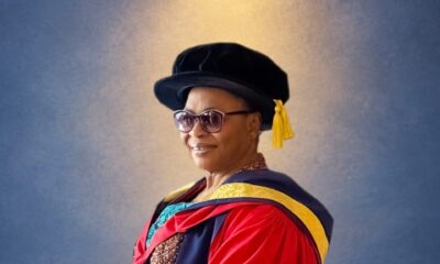 Folorunso Alakija wearing a red doctoral gown, black cap, and tinted glasses.