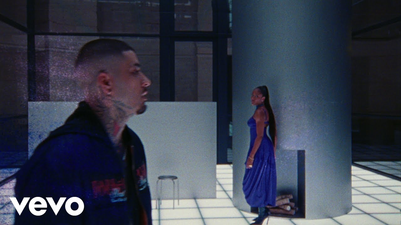 Ayra Starr in a royal blue satin dress and Zayn in a dark jacket in the official Heaven Baby music video.